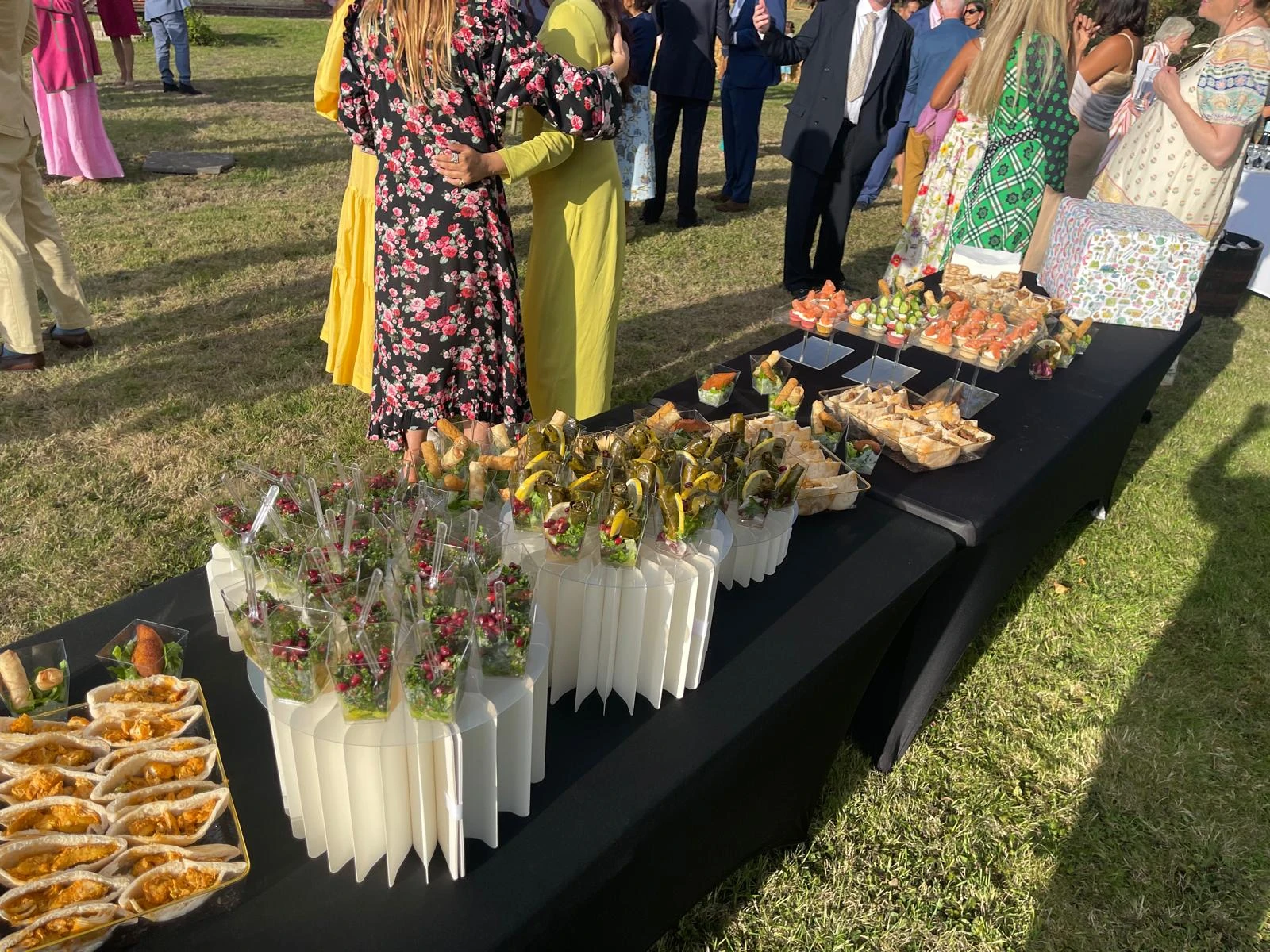 Guests around a David's Deli catering table